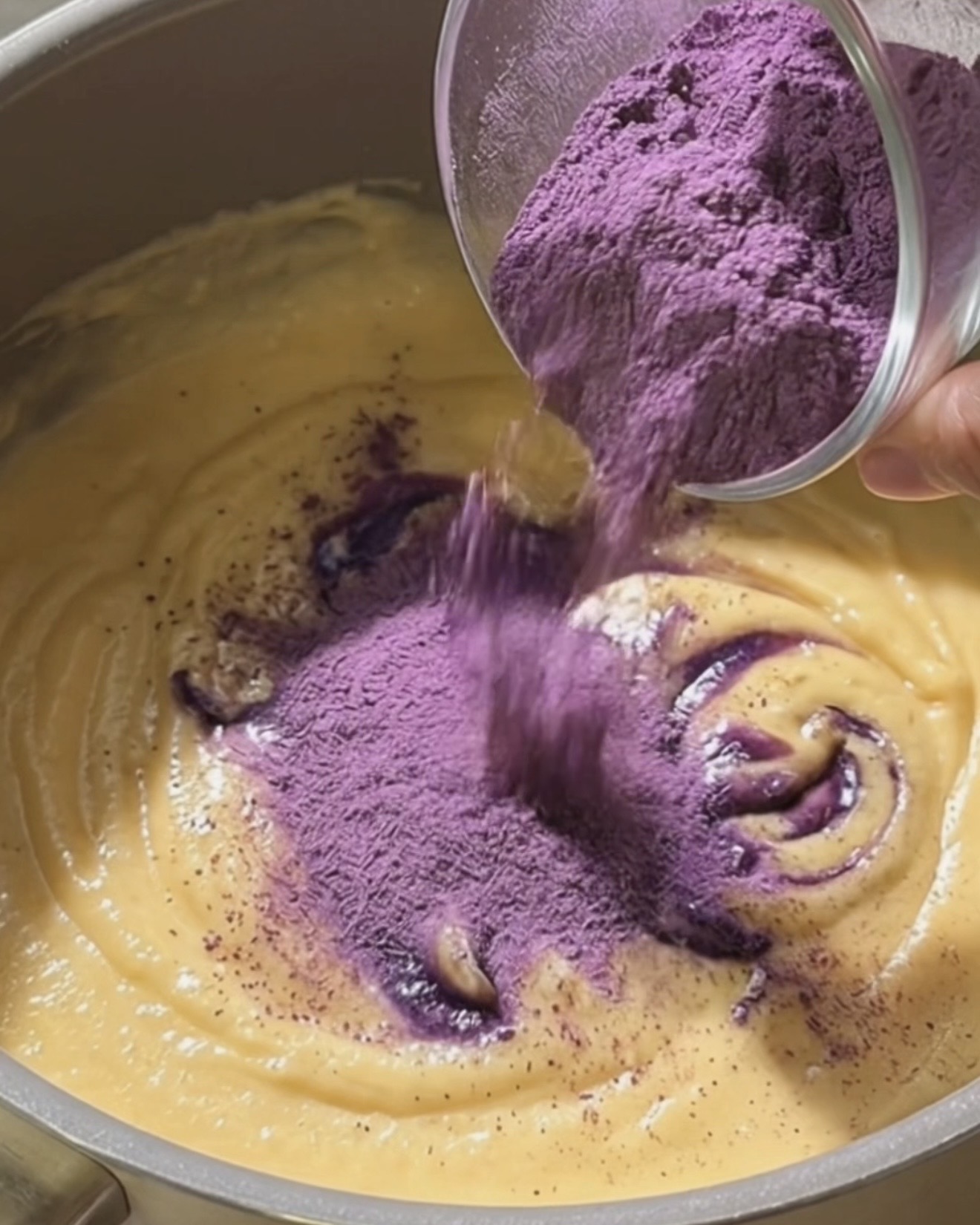 UBE NOLIA Ube-Pulver in die Kokos- und Kondensmilch rühren, um Ube Halaya-Füllung für Dadar Gulung zuzubereiten